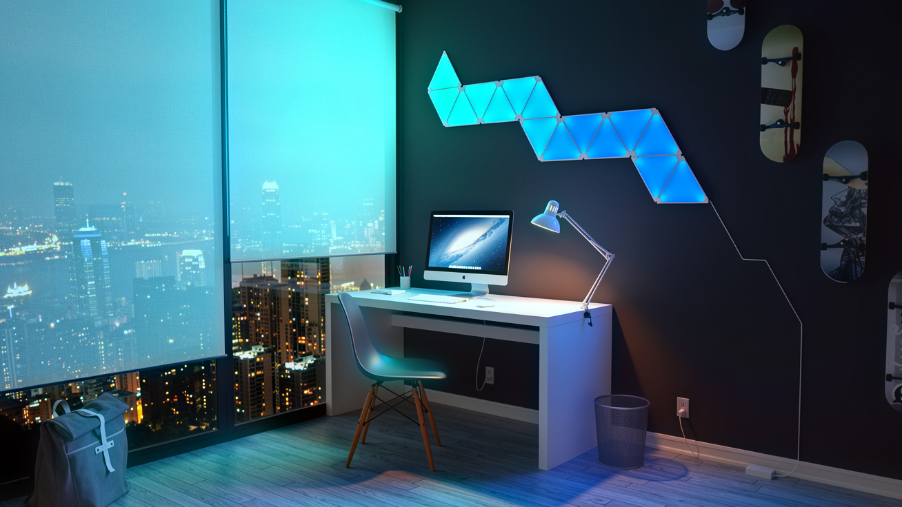 Budget desk setup with RGB triangle light panels, ambient lighting and gaming accessories under £50