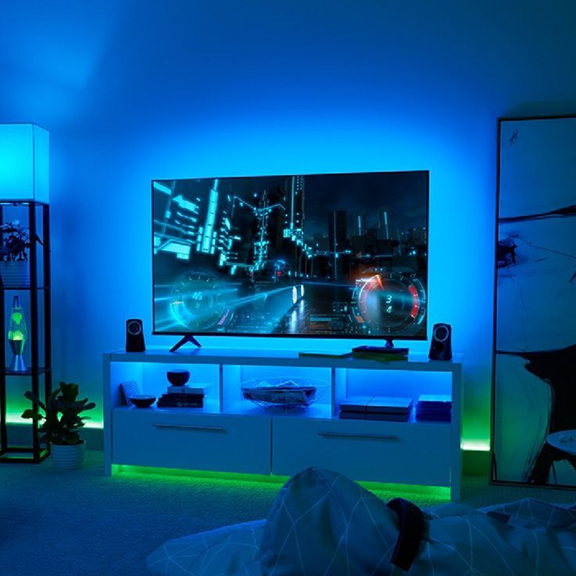 Ambient TV lighting creating a blue gaming-room glow around the screen and entertainment setup