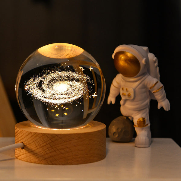 Galaxy globe lamp on wood base emitting soft warm white light for bedside decor
