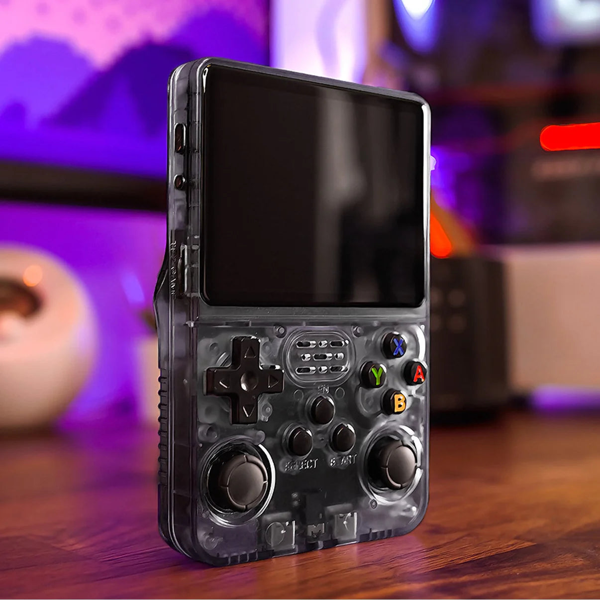 Black retro game handheld beside monitor, travel gaming console design
