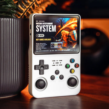 White retro handheld game console near books, minimalist gaming setup