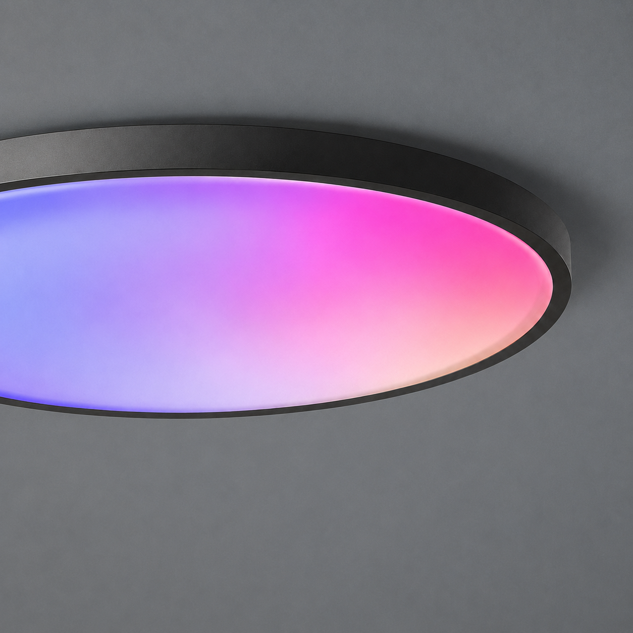 Close-up of a slim black RGB ceiling light with blended purple and pink illumination