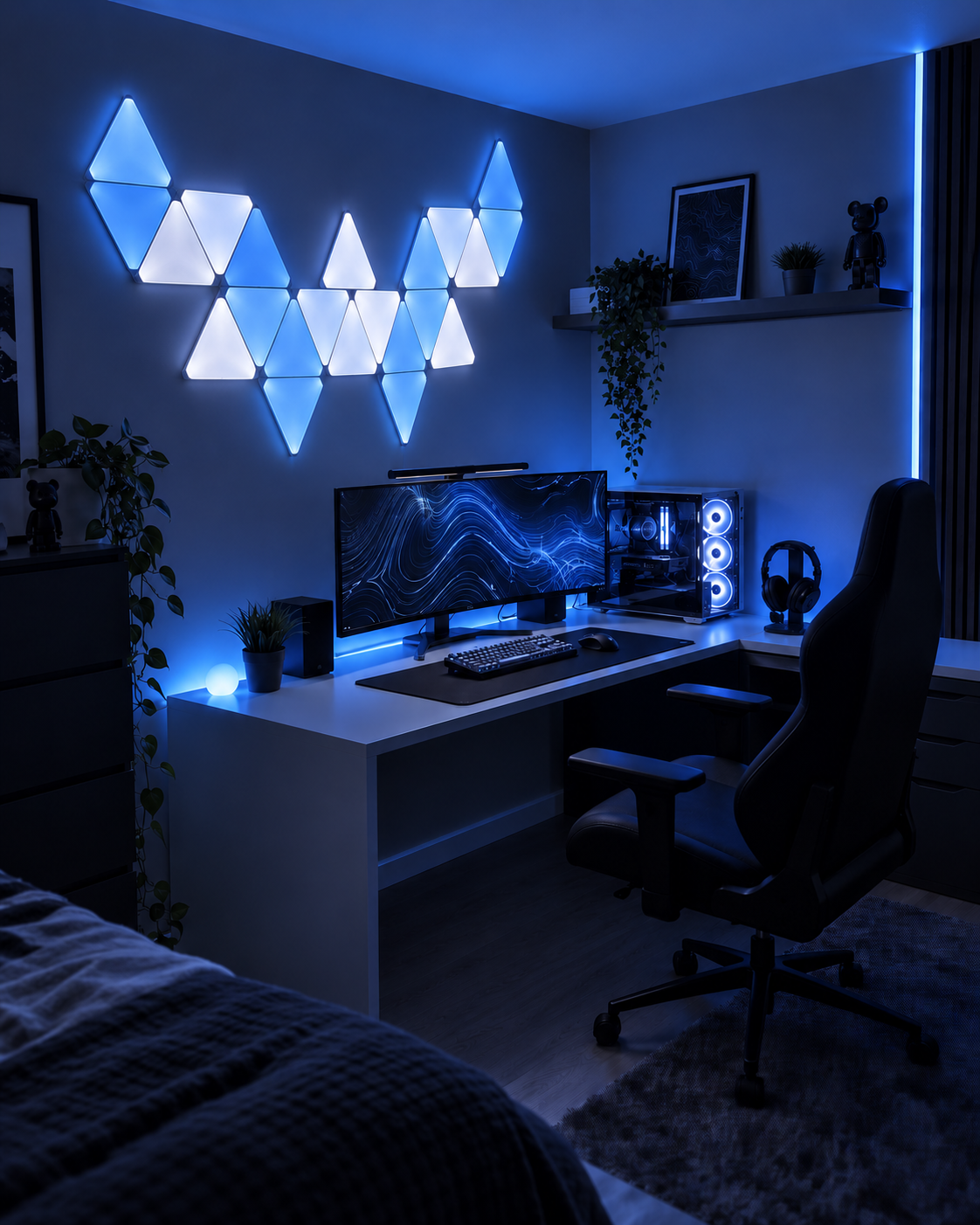 Blue and white triangle LED panels installed above a modern gaming desk setup