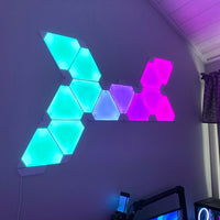Triangle LED wall light panels installed in a modern bedroom for soft ambient lighting