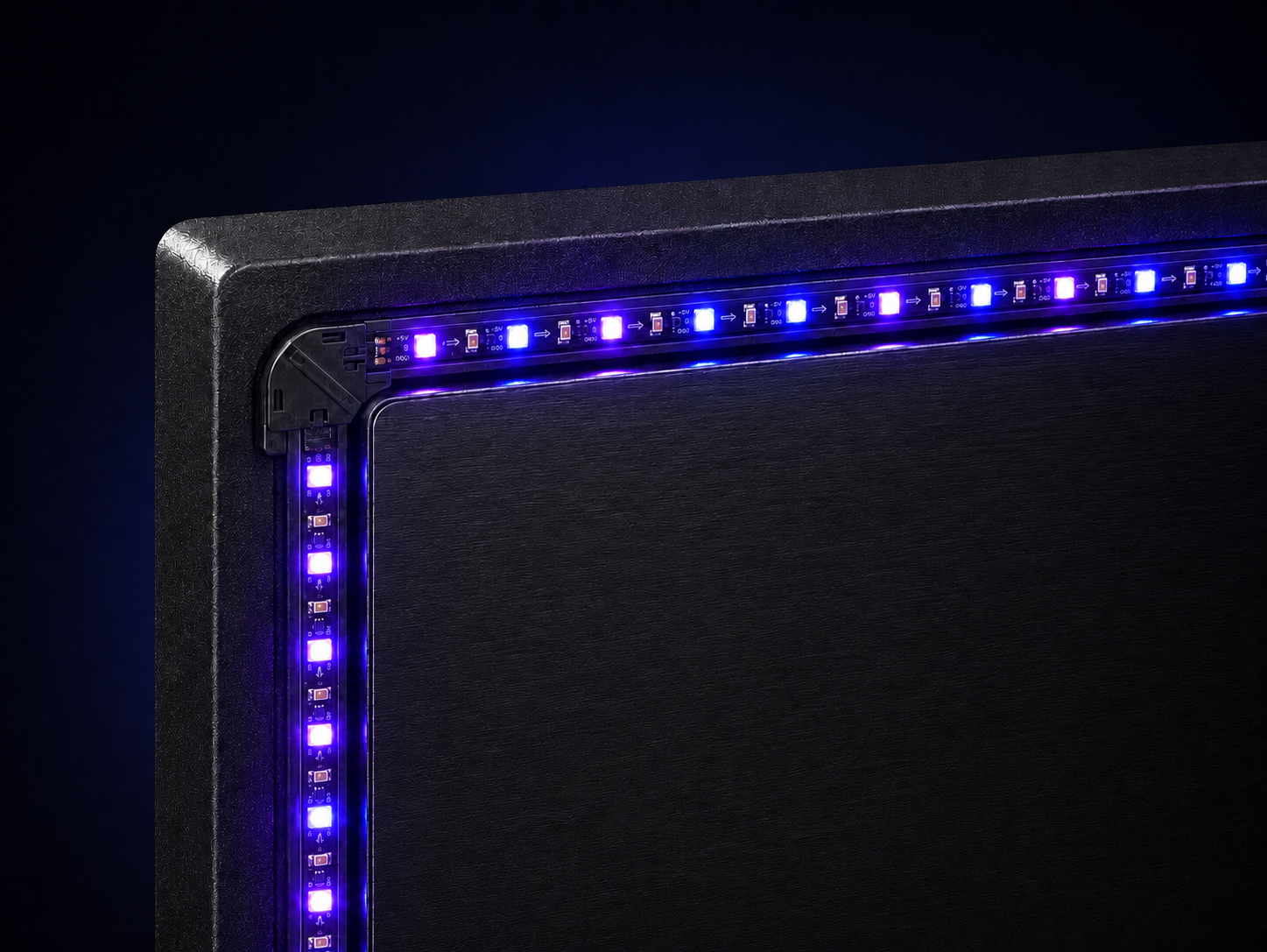 TV backlight LED strip routed around a screen corner with a corner guide for a clean installation