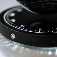 Close-up of magnetic clock base showing levitation detail of 3D printed moon lamp for futuristic home interiors.