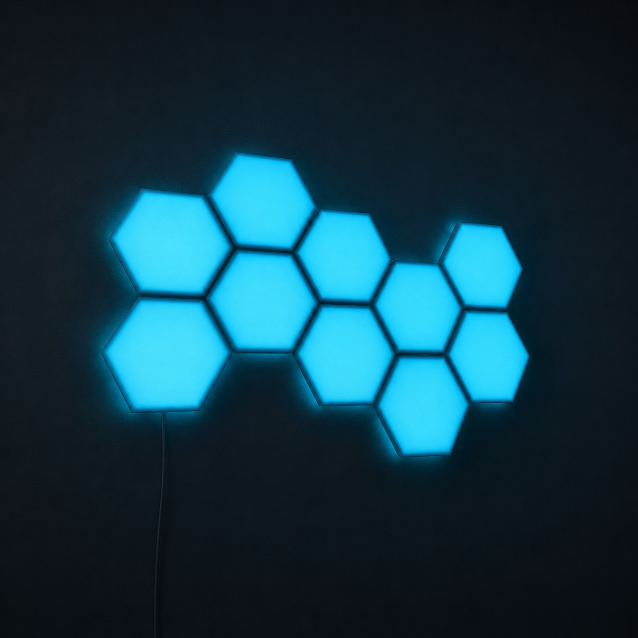 Blue RGBIC hexagon light panels mounted on a dark wall with soft ambient backlight