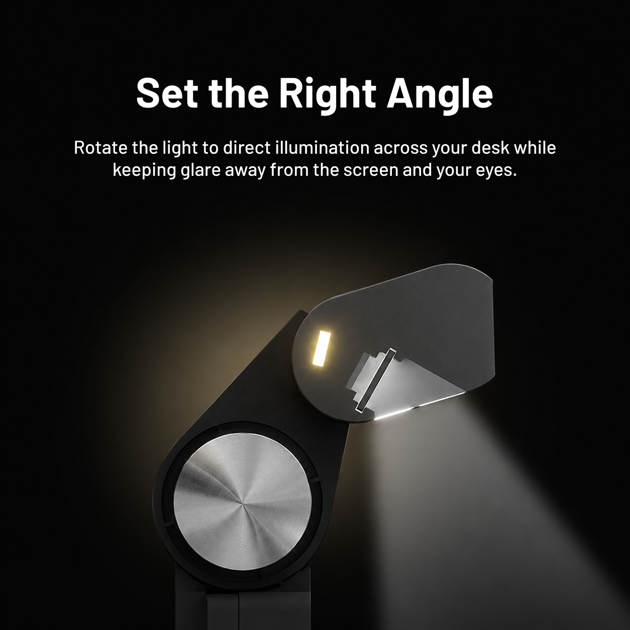 Adjustable monitor light bar angle directing illumination towards the desk