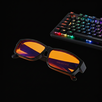 Blue light blocking gaming glasses beside RGB keyboard setup for long gaming sessions