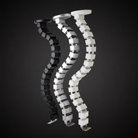 Flexible cable management tube shown in black and white color options for desk wire organization