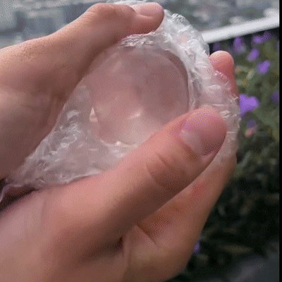 Close-up of crystal ball lamp showing clear glass globe and warm white light