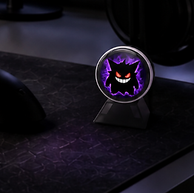 Zyko digital pin badge displaying animated artwork on a gaming desk