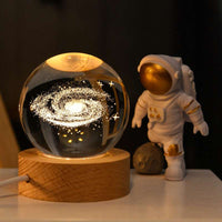 Galaxy globe lamp on wood base emitting soft warm white light for bedside decor