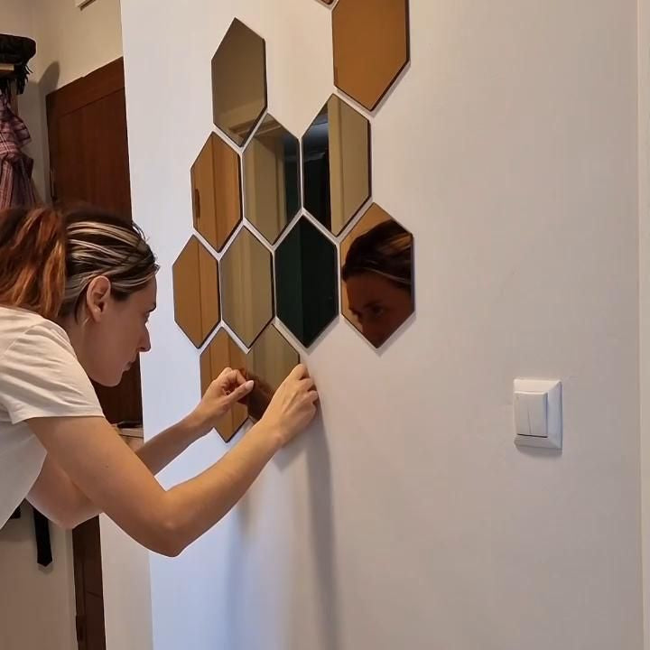person installing amazing mirrors on interior wall showing easy peel and stick setup with lightweight acrylic panels