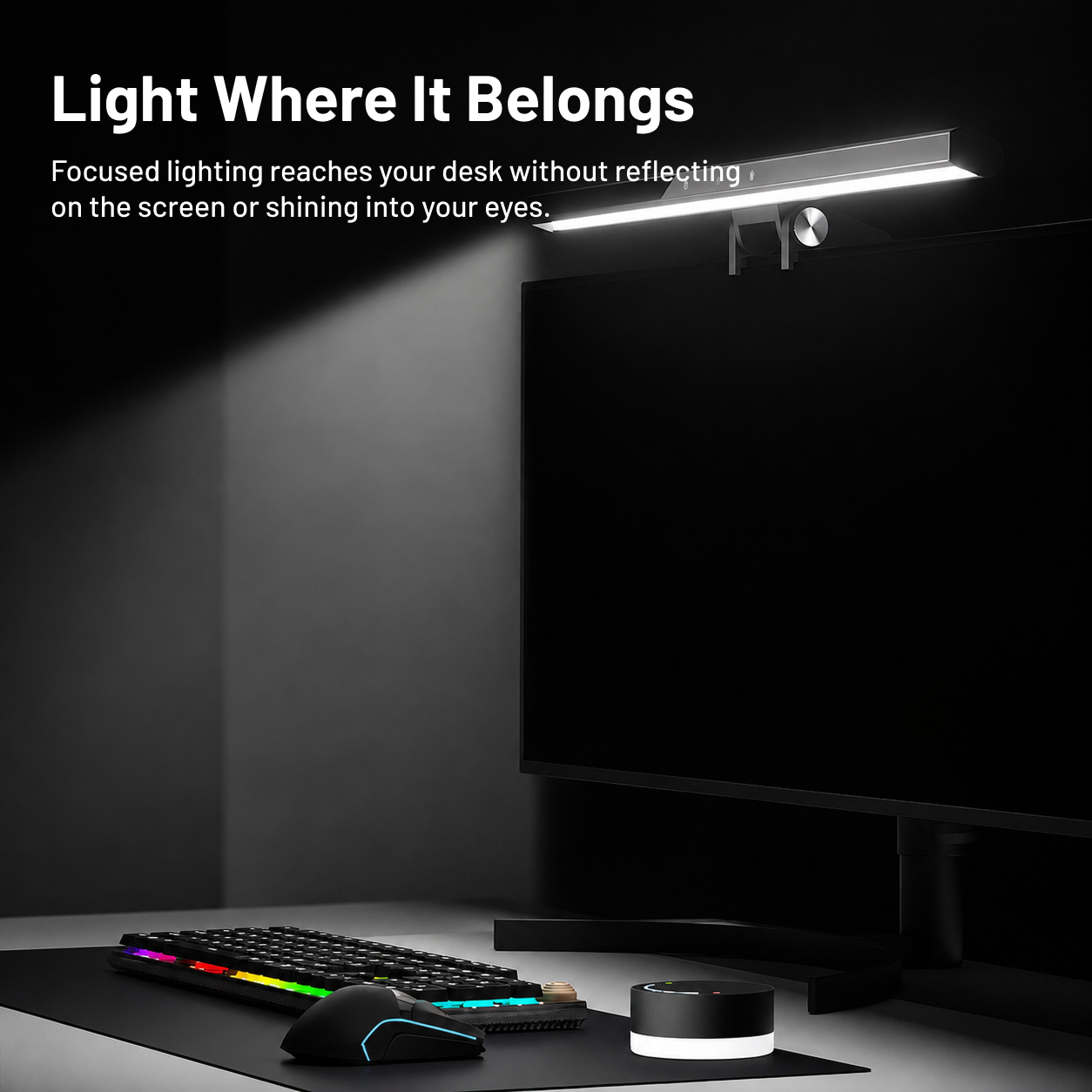 Monitor light bar directing focused light across a desk without reflecting on the screen