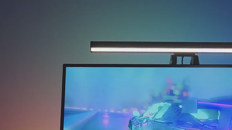 RGB monitor light bar casting focused light across a desk with rear RGB backlighting behind the screen