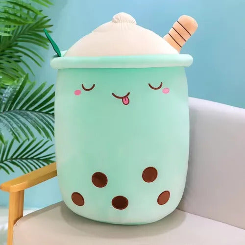 Green boba tea plush toy smiling on tabletop, from Zyko’s Everyday Comforts Collection